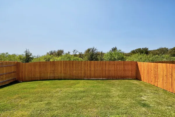 a view of deck and wooden fence