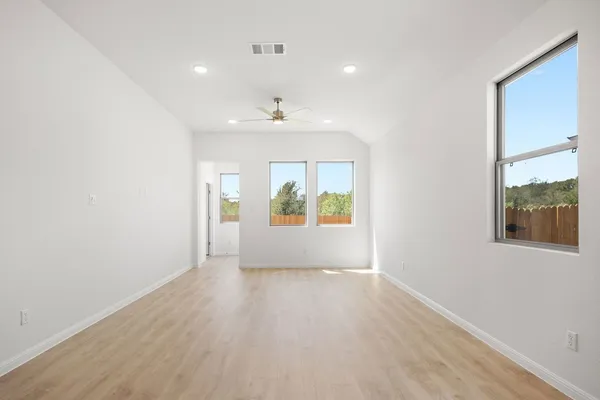 an empty room with windows and entrance