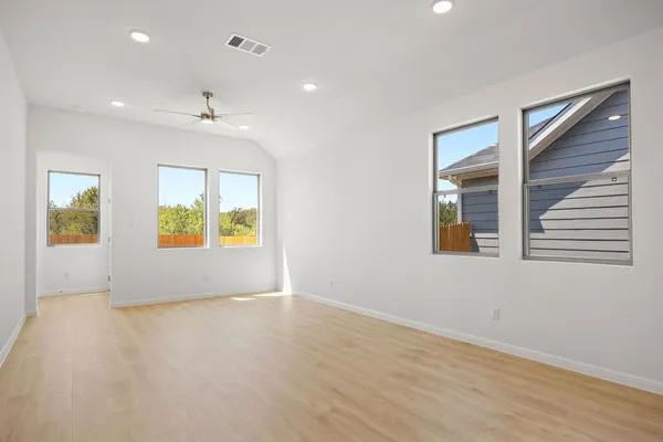 an empty room with windows and entrance
