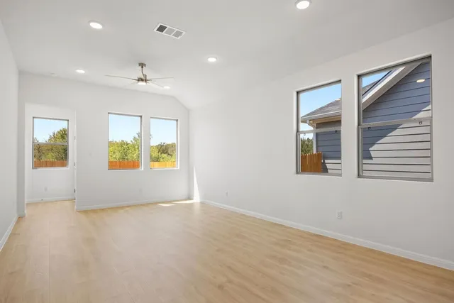 an empty room with windows and entrance