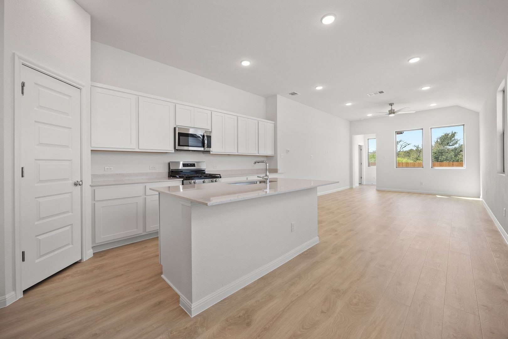 278 Bendecido Loop Elgin, TX 78621 - Photo 9 of 37 a kitchen with a refrigerator and a stove top oven