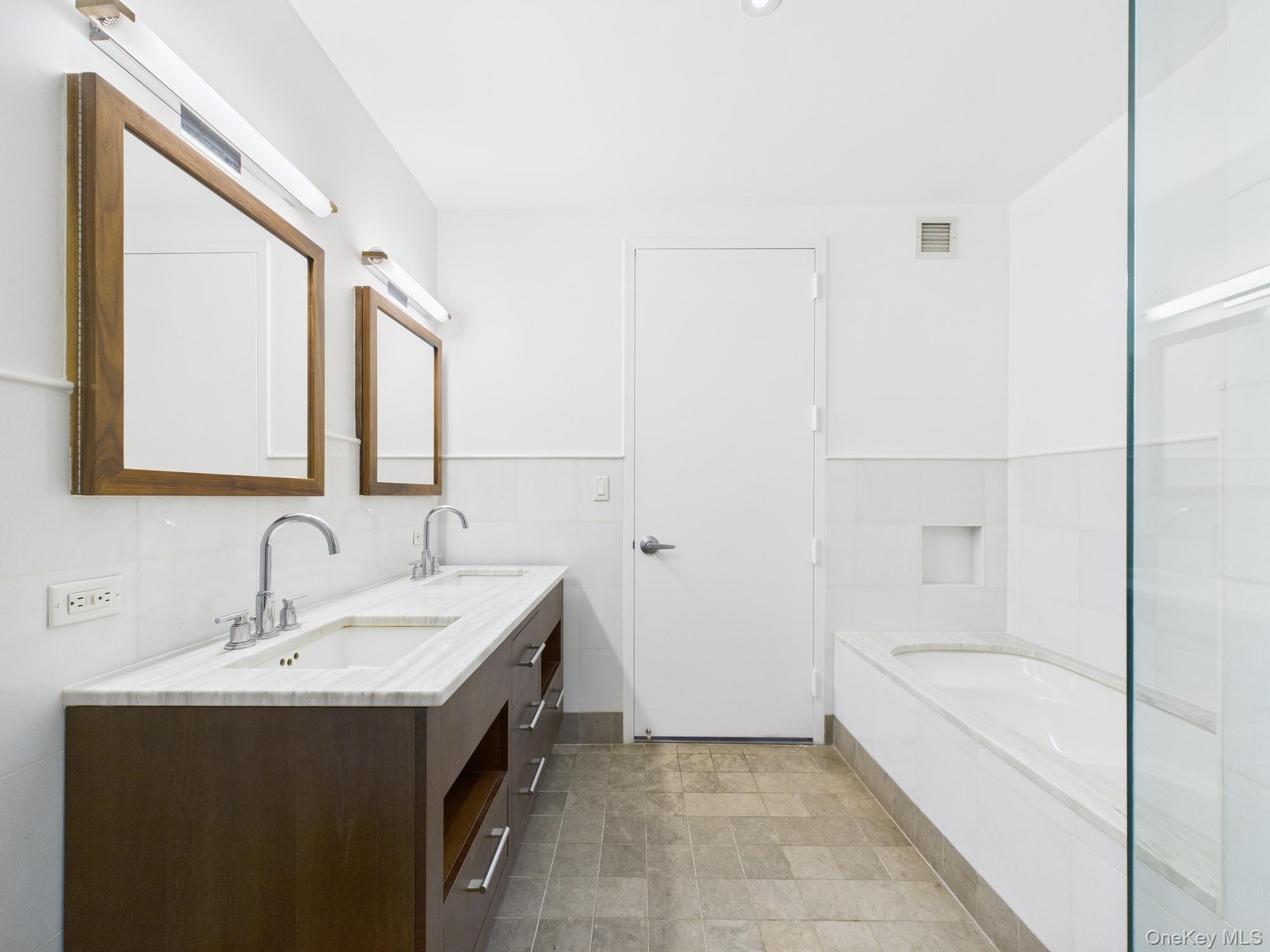 10 West End Avenue, Unit 20B Manhattan, NY 10023 - Photo 19 of 41 Full bathroom with a bath and double vanity