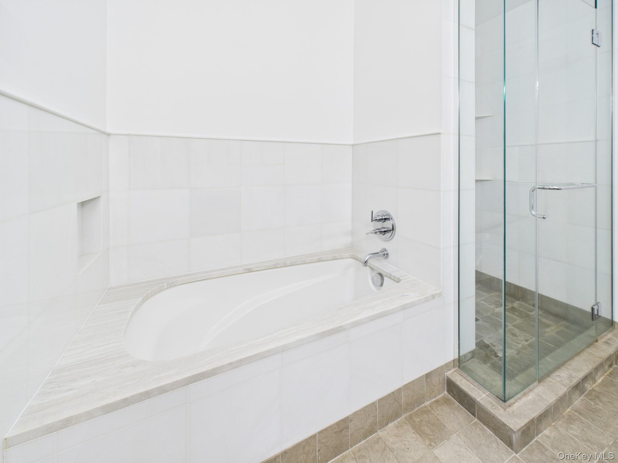 10 West End Avenue, Unit 20B Manhattan, NY 10023 - Photo 20 of 41 Full bathroom featuring a bath and a shower stall