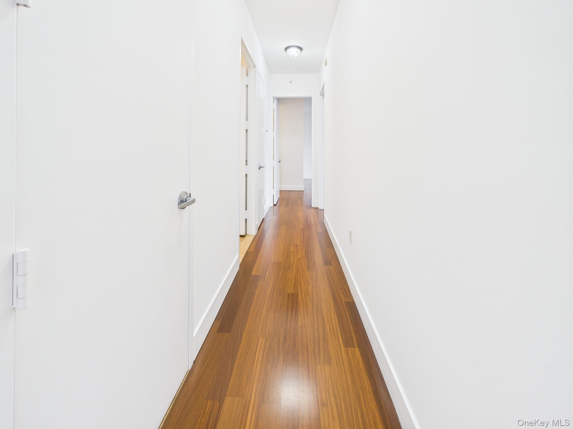 10 West End Avenue, Unit 20B Manhattan, NY 10023 - Photo 29 of 41 Hallway featuring dark wood-style floors and baseboards