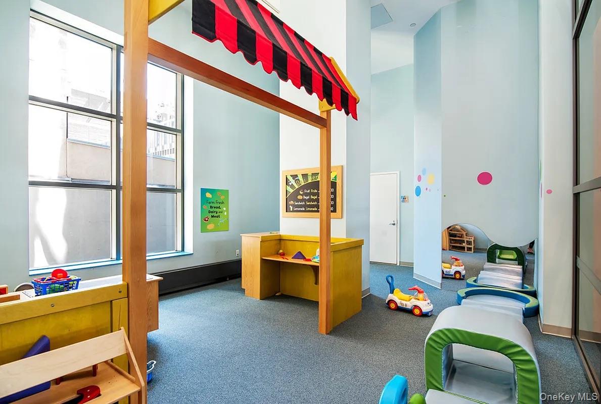 10 West End Avenue, Unit 20B Manhattan, NY 10023 - Photo 34 of 41 Game room featuring a towering ceiling