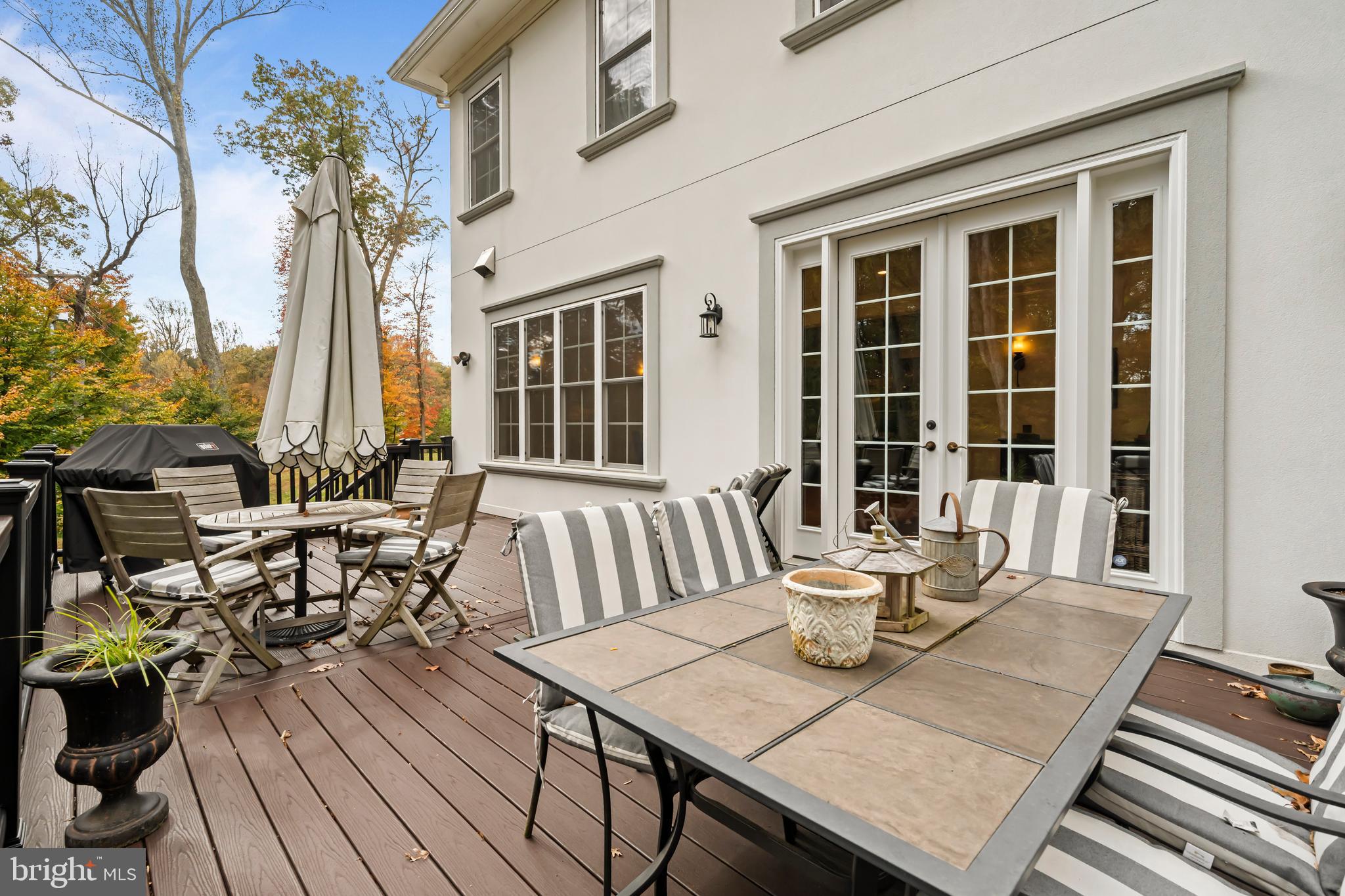 13025 Yates Ford Road Clifton, VA 20124 - Photo 15 of 82 a view of a patio with table and chairs and wooden floor