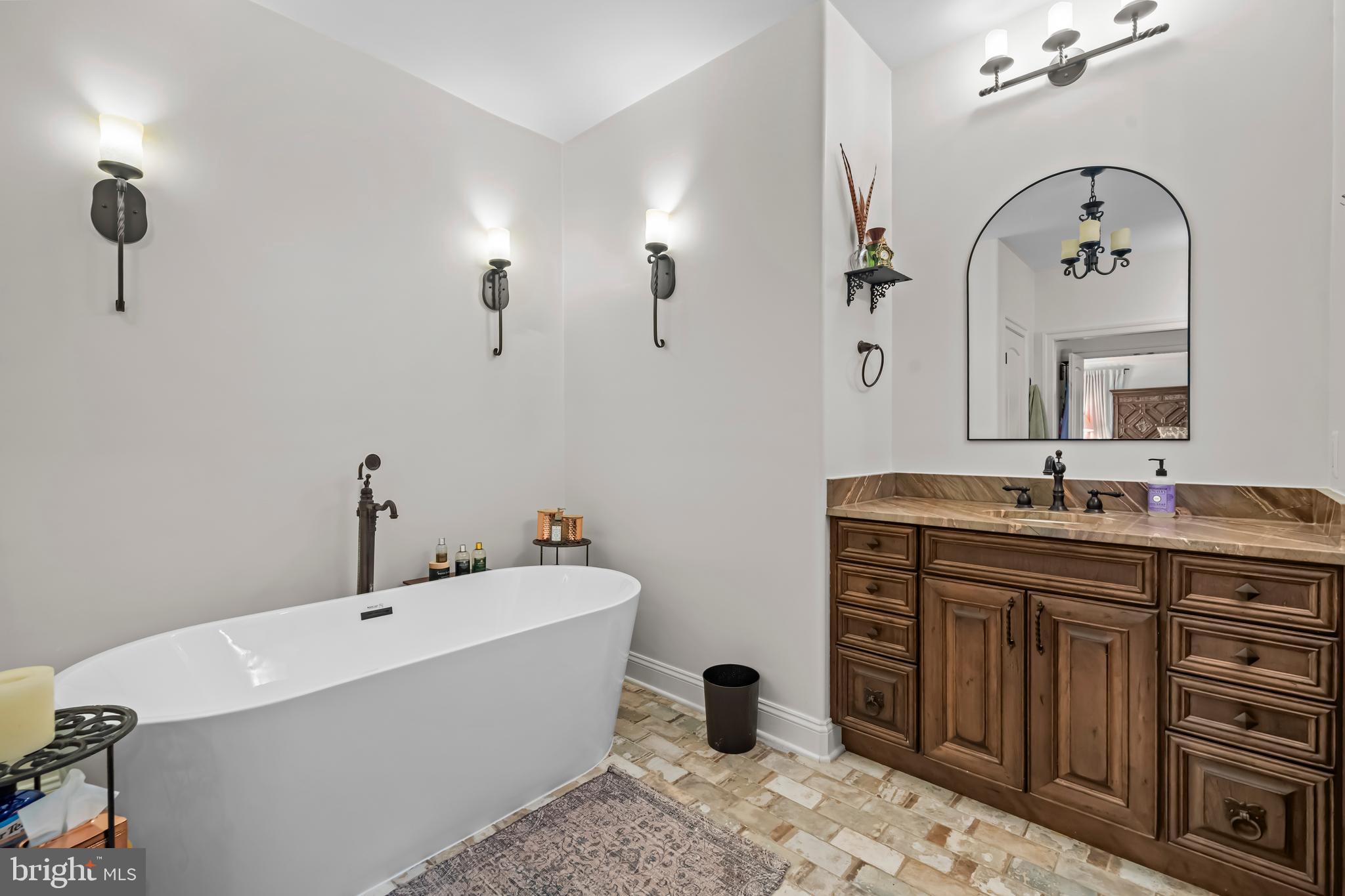 13025 Yates Ford Road Clifton, VA 20124 - Photo 36 of 82 a bathroom with a tub sink and mirror