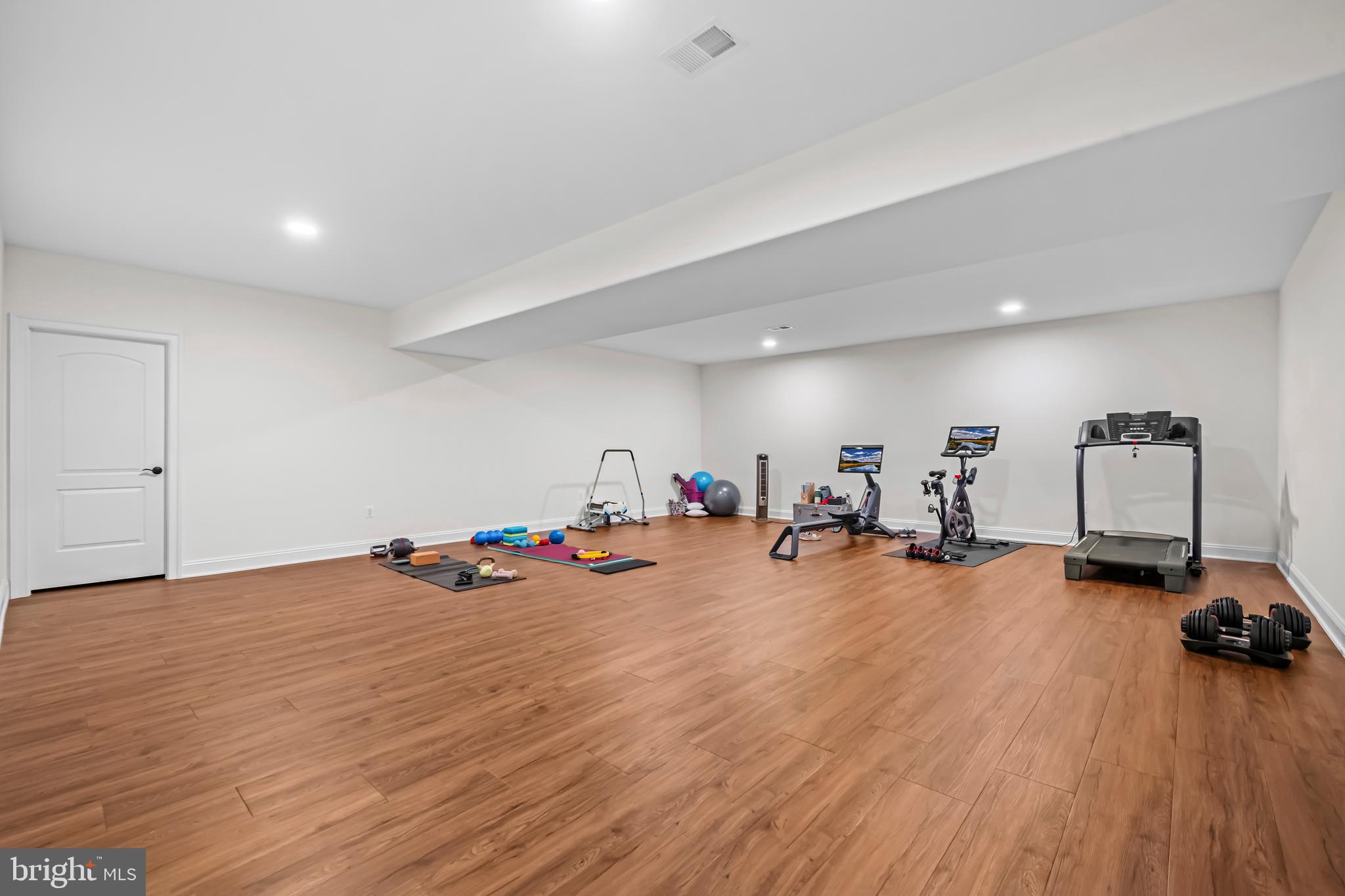 13025 Yates Ford Road Clifton, VA 20124 - Photo 52 of 82 a view of a room with gym equipment and wooden floor
