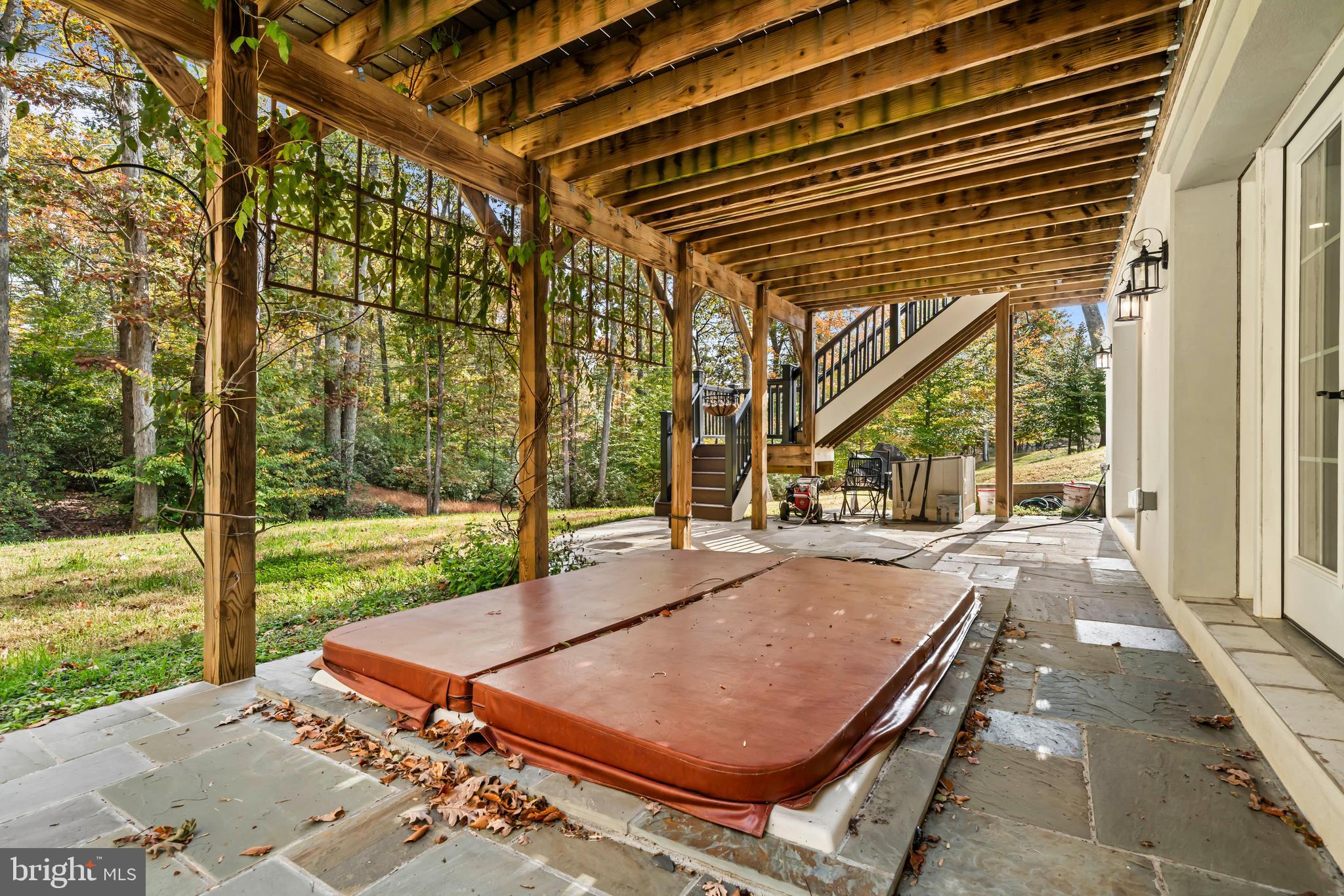 13025 Yates Ford Road Clifton, VA 20124 - Photo 57 of 82 a view of a backyard with floor to ceiling windows and a lawn chair