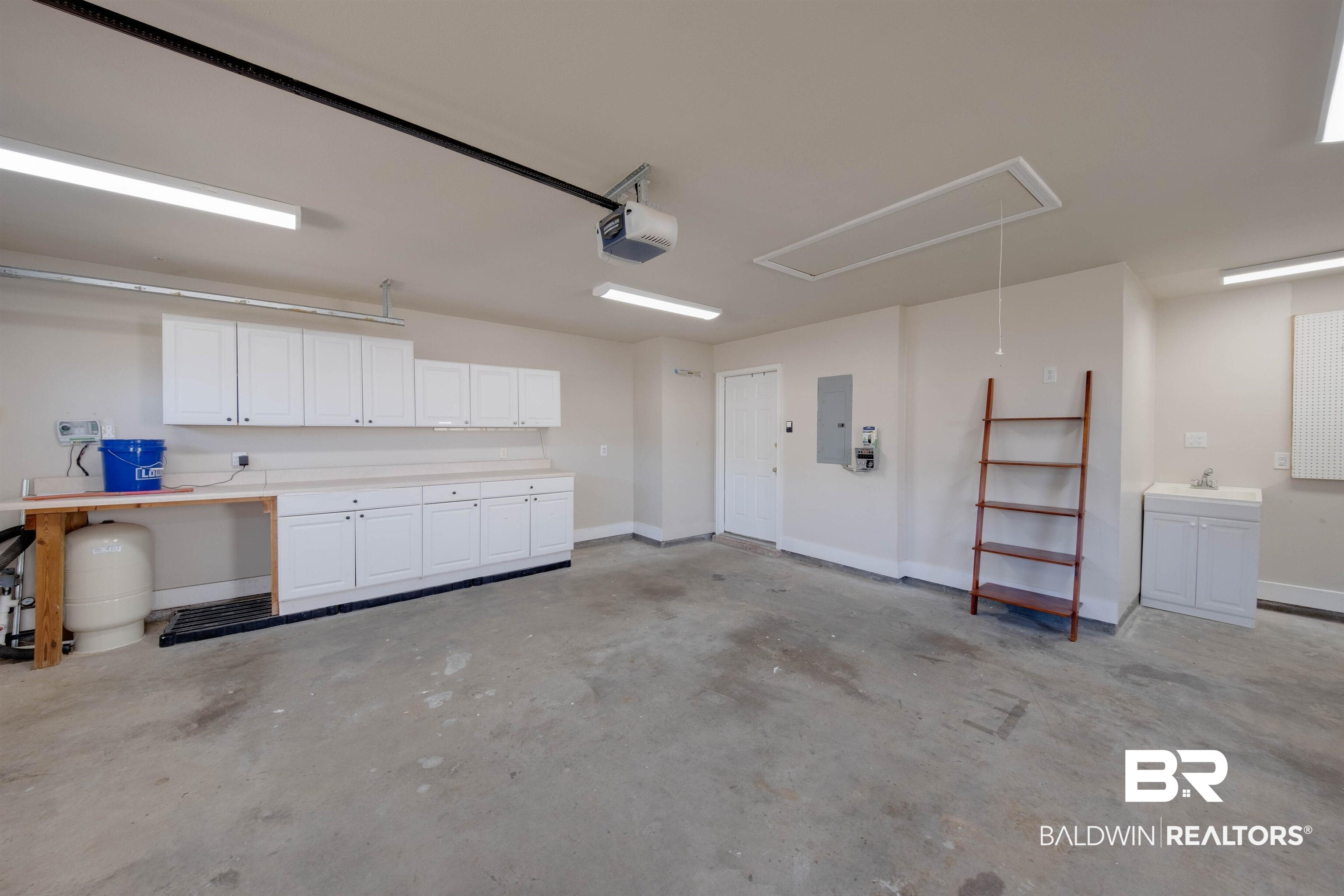 9462 Lakeview Drive Foley, AL 36535 - Photo 25 of 50 Garage with a garage door opener, electric panel, and sink
