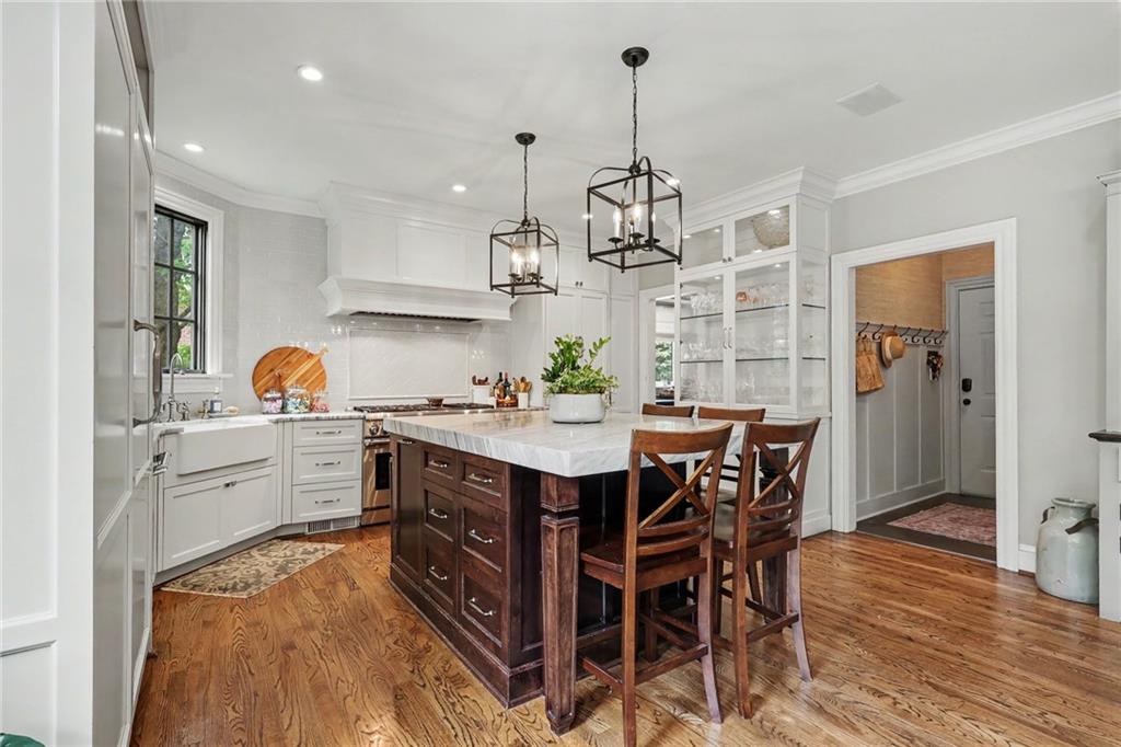 2375 Massey Lane Decatur, GA 30033 - Photo 10 of 88 a kitchen with stainless steel appliances kitchen island granite countertop a table chairs in it and wooden floors