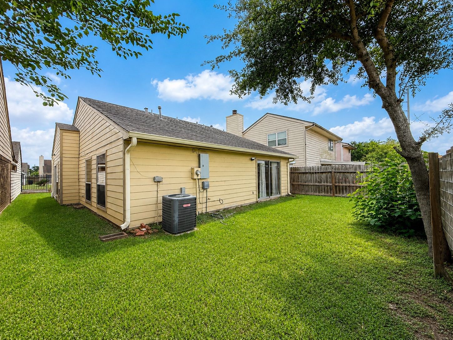 11840 Spring Grove Drive Houston, TX 77099 - Photo 27 of 27 Beautiful backyard with mature trees and lush green lawn — ideal for entertaining