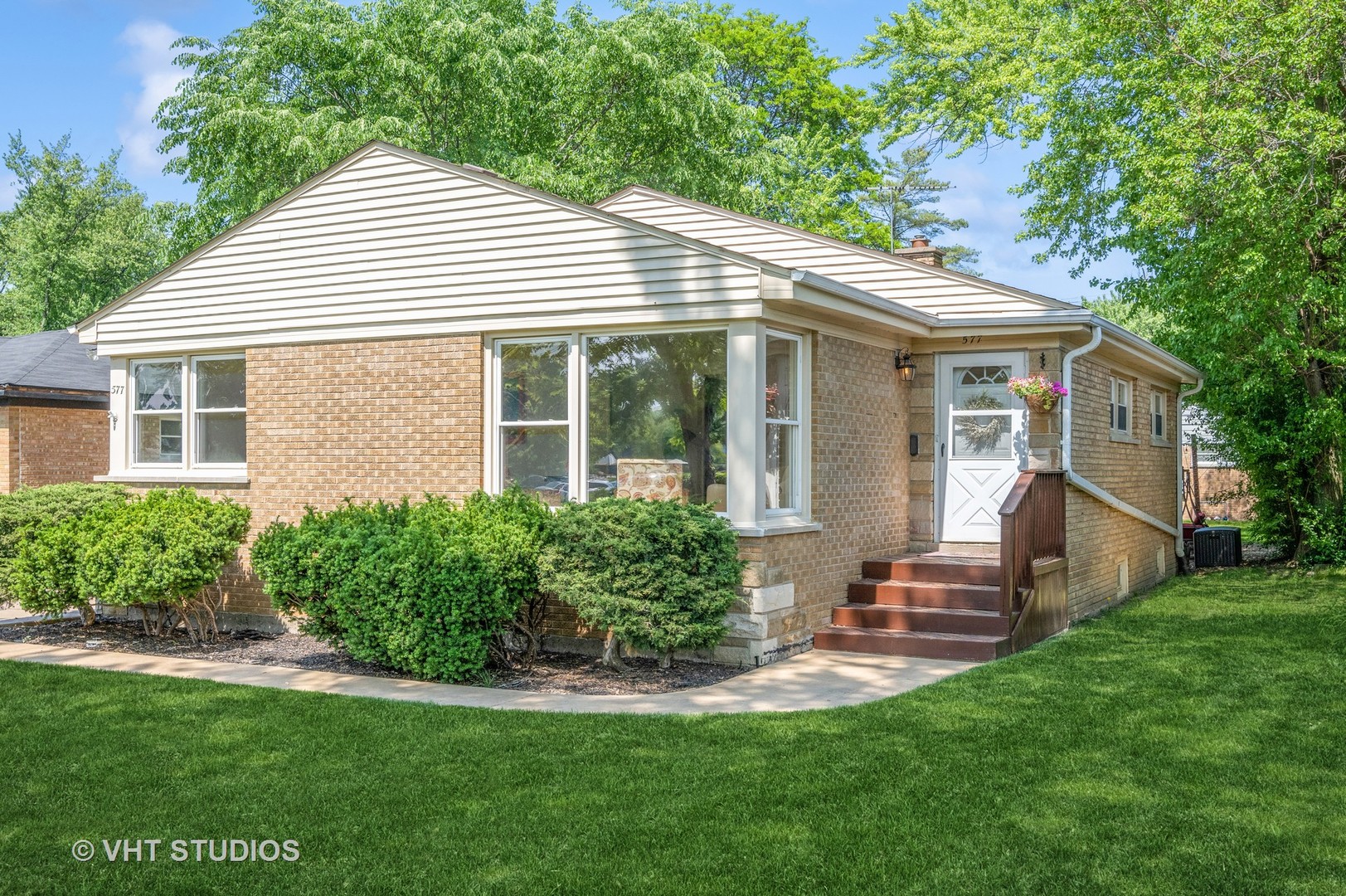577 Ridge Road Highland Park, IL 60035 - Photo 1 of 20 a view of a house with a yard and lawn chairs under large tree