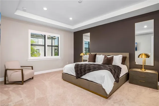 a spacious bedroom with a bed and a couch