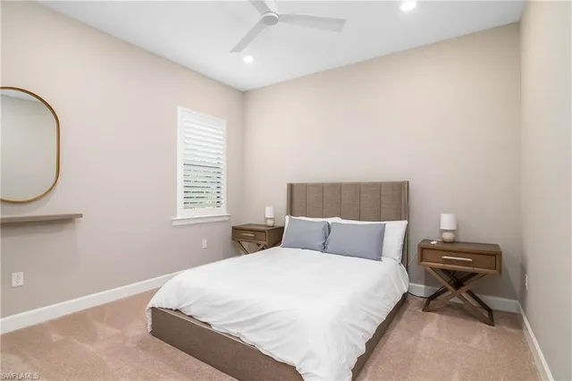 a bedroom with a bed a mirror and a window