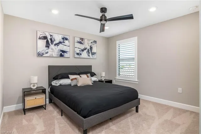 a bedroom with a bed and a painting on the wall