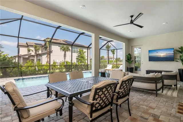 a view of a patio with a table chairs and a small yard