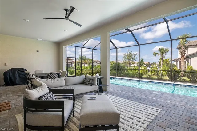 a living room with furniture and a floor to ceiling window