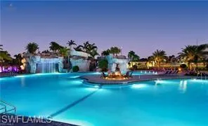 a view of a swimming pool with a table and chairs