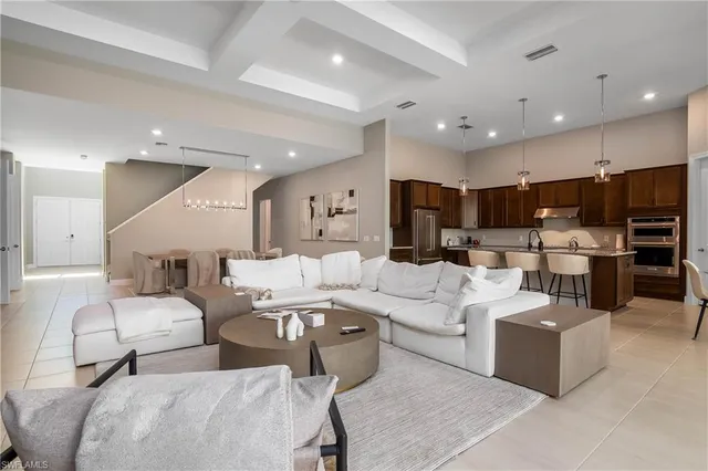 a living room with lots of furniture and kitchen view