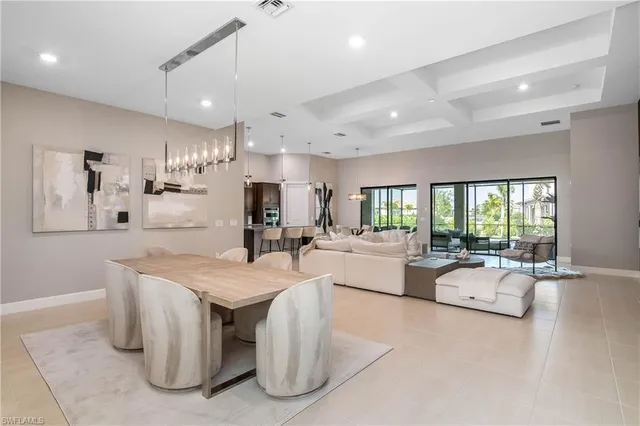 a large dining hall with stainless steel appliances kitchen island granite countertop furniture and a large window