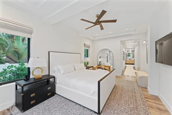 a bedroom with a bed a couch and a window