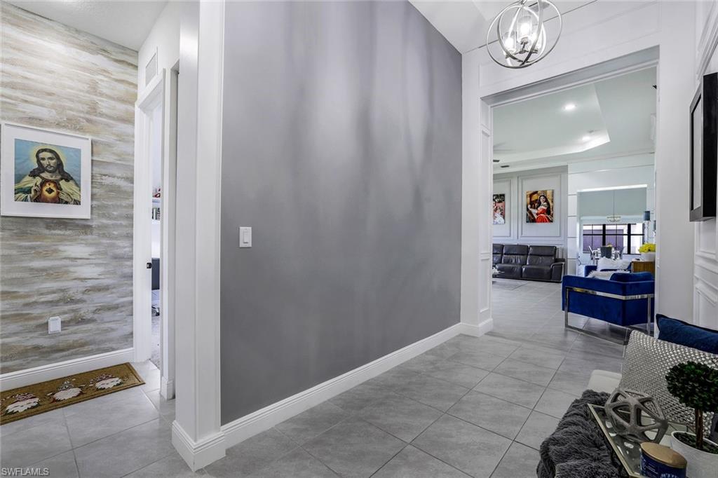 4795 Rosetta Terrace Immokalee, FL 34142 - Photo 2 of 27 Corridor with light tile patterned floors, a chandelier, and recessed lighting