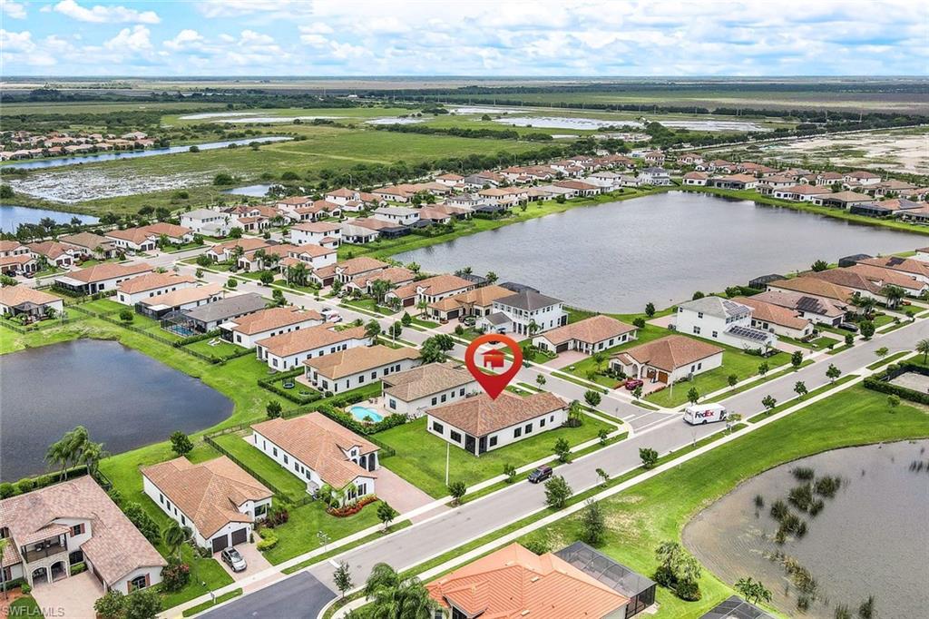 4795 Rosetta Terrace Immokalee, FL 34142 - Photo 26 of 27 Aerial perspective of suburban area featuring a large body of water