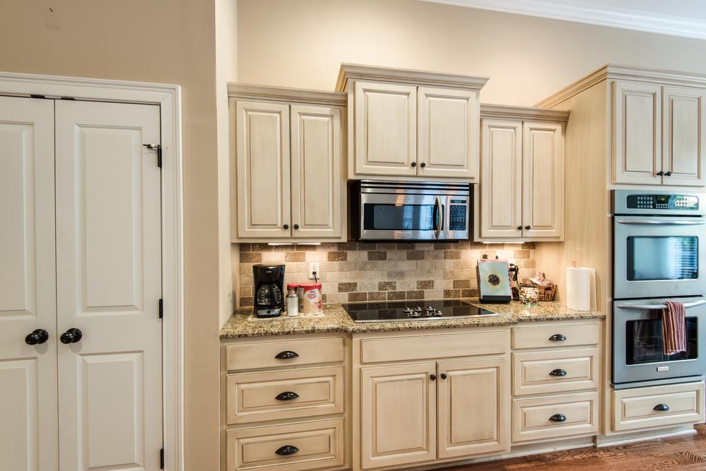 7302 Allans Ridge Lane Fairview, TN 37062 - Photo 14 of 30 a kitchen with granite countertop white cabinets stainless steel appliances and sink
