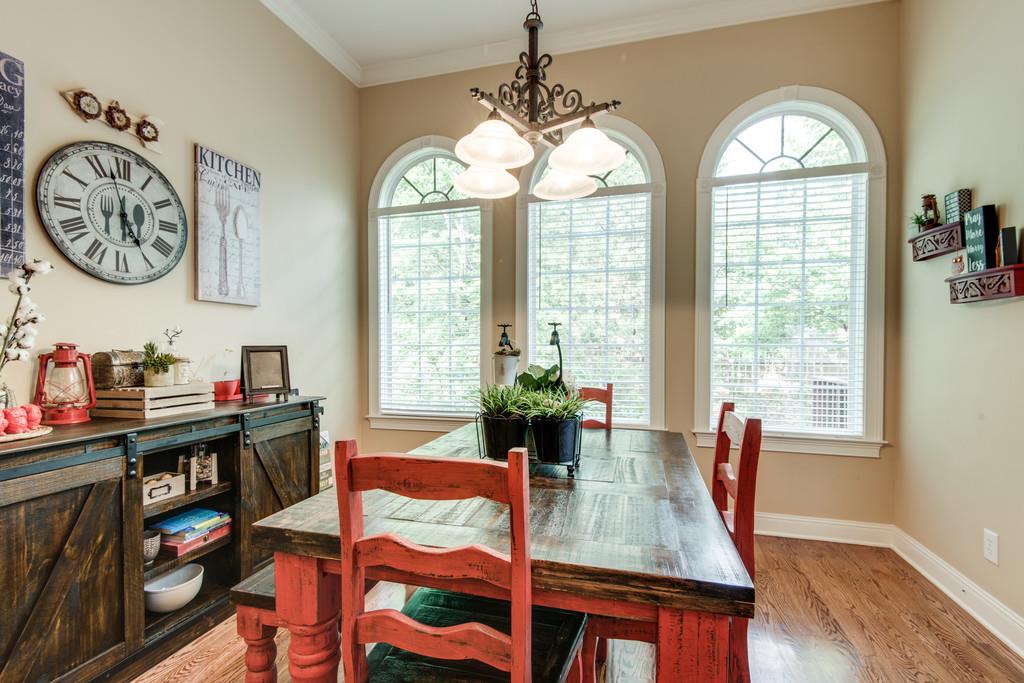 7302 Allans Ridge Lane Fairview, TN 37062 - Photo 15 of 30 a view of a dining room with furniture a chandelier and wooden floor