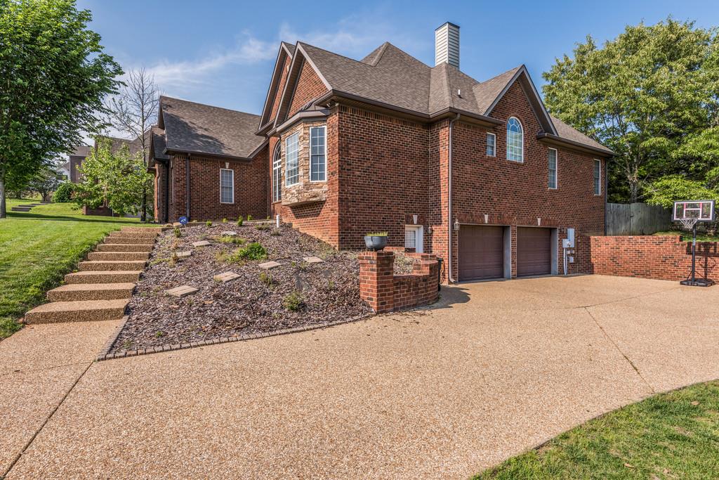 7302 Allans Ridge Lane Fairview, TN 37062 - Photo 3 of 30 a front view of a house with a yard and garage