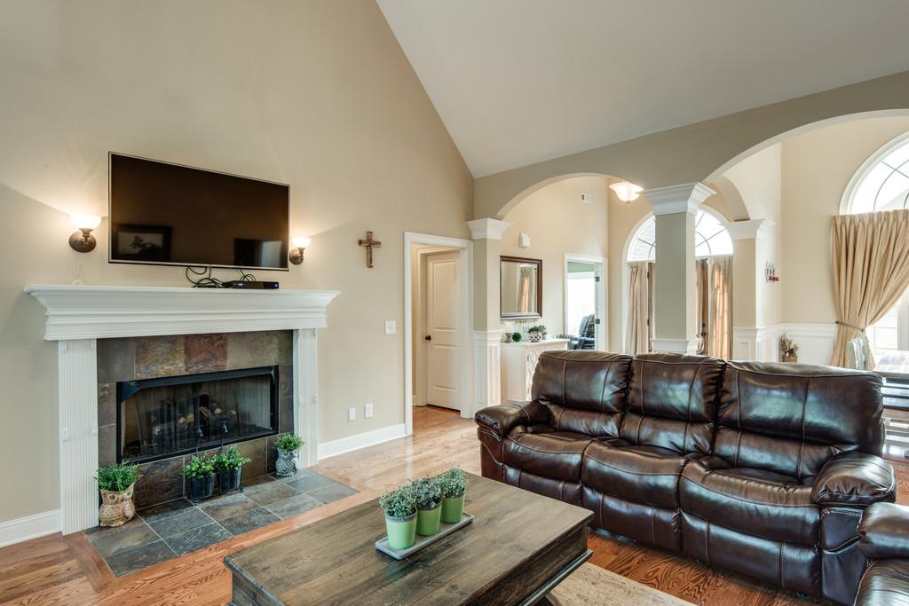 7302 Allans Ridge Lane Fairview, TN 37062 - Photo 9 of 30 a living room with furniture a flat screen tv and a fireplace