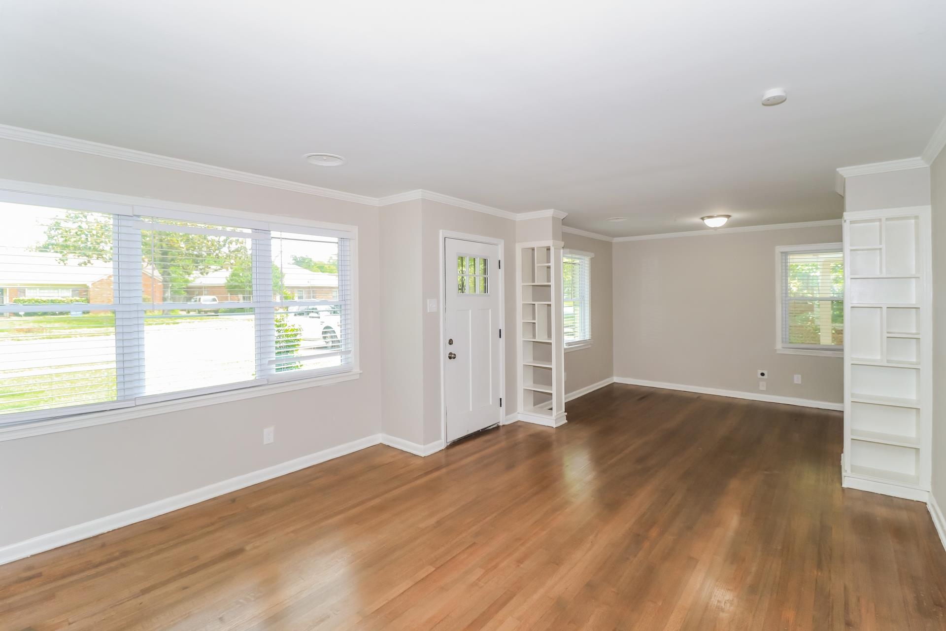 5113 Helene Road Memphis, TN 38117 - Photo 3 of 18 an empty room with wooden floor and windows