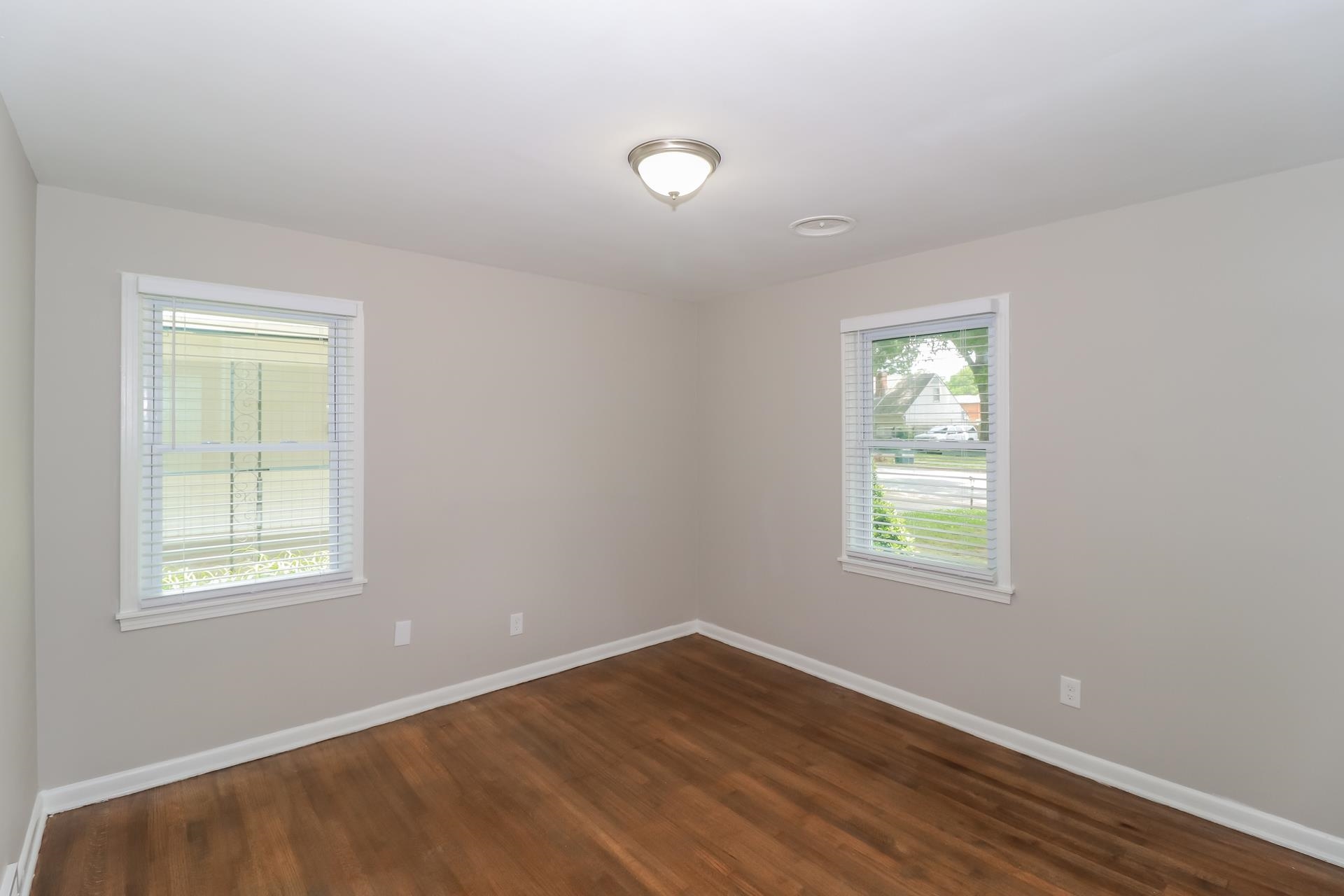5113 Helene Road Memphis, TN 38117 - Photo 9 of 18 an empty room with wooden floor and windows
