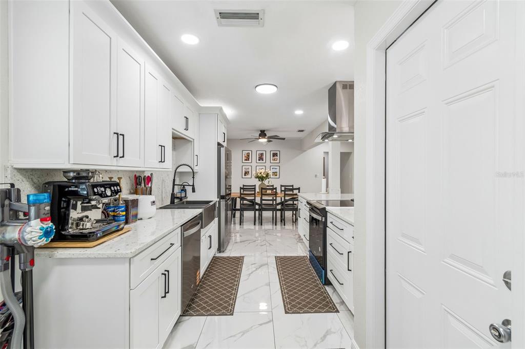 1618 Barry Road Clearwater, FL 33756 - Photo 16 of 71 a kitchen with lots of counter top space and cabinets