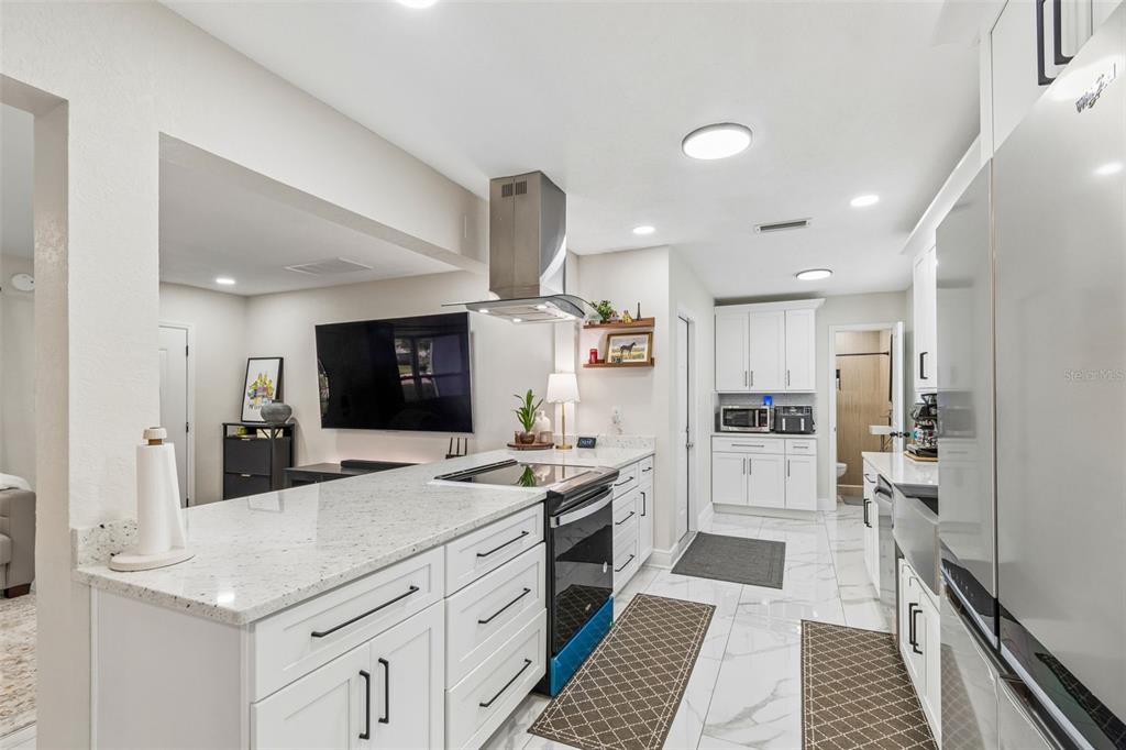 1618 Barry Road Clearwater, FL 33756 - Photo 19 of 71 a kitchen with stainless steel appliances kitchen island granite countertop a refrigerator and a stove top oven