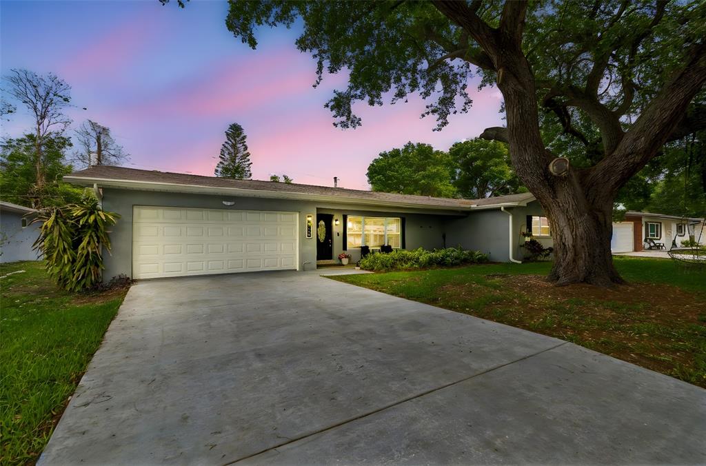 1618 Barry Road Clearwater, FL 33756 - Photo 2 of 71 a front view of a house with a garden and trees