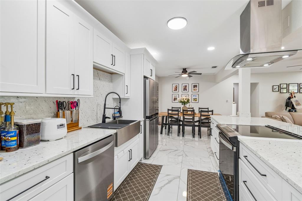 1618 Barry Road Clearwater, FL 33756 - Photo 21 of 71 a kitchen with granite countertop a sink and cabinets