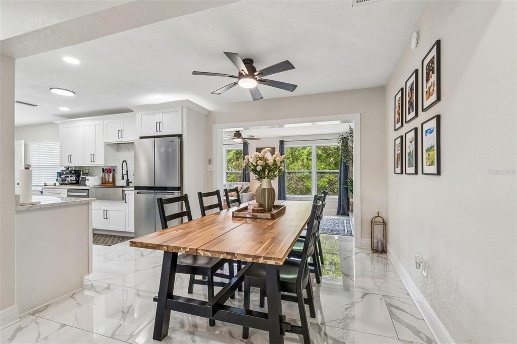 1618 Barry Road Clearwater, FL 33756 - Photo 28 of 71 a view of a dining room with furniture and a large window
