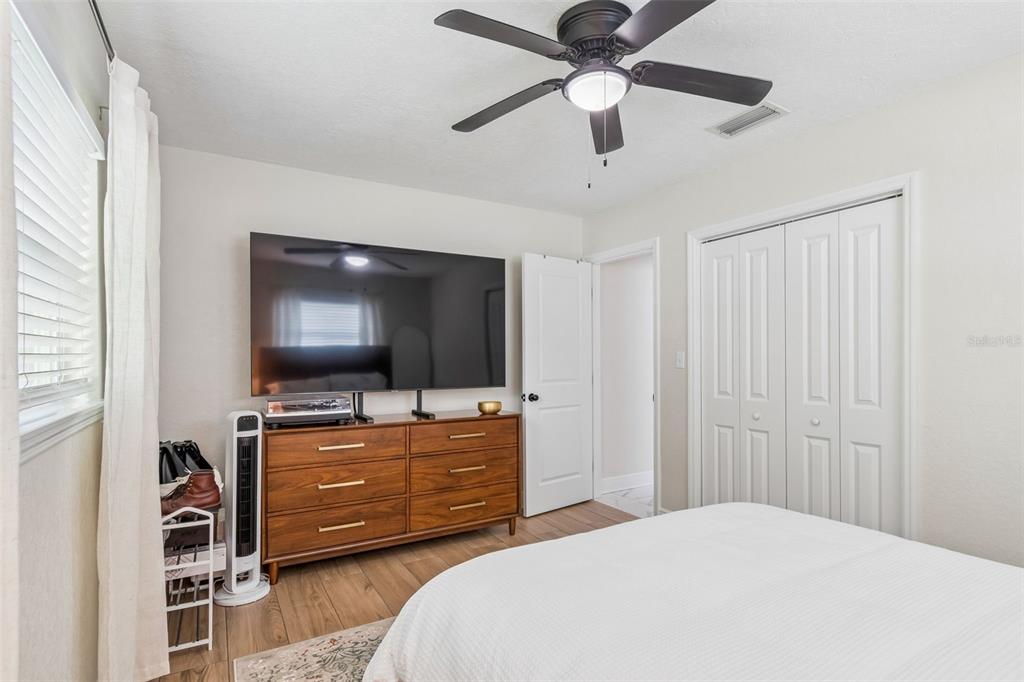 1618 Barry Road Clearwater, FL 33756 - Photo 31 of 71 a bedroom with a bed and a flat screen tv