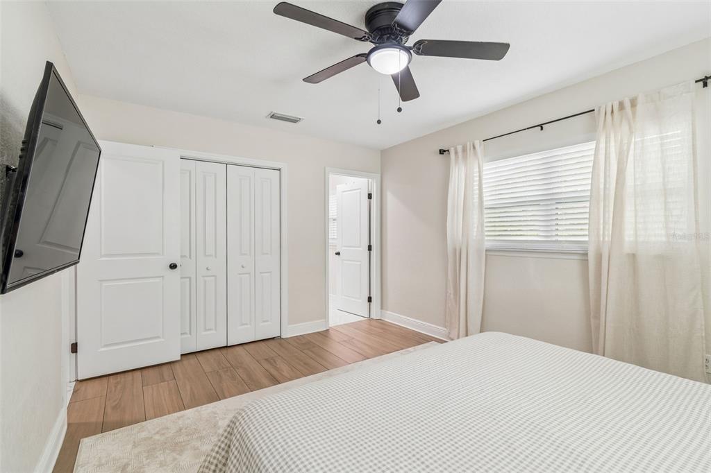 1618 Barry Road Clearwater, FL 33756 - Photo 34 of 71 a bedroom with a large bed and a flat tv screen