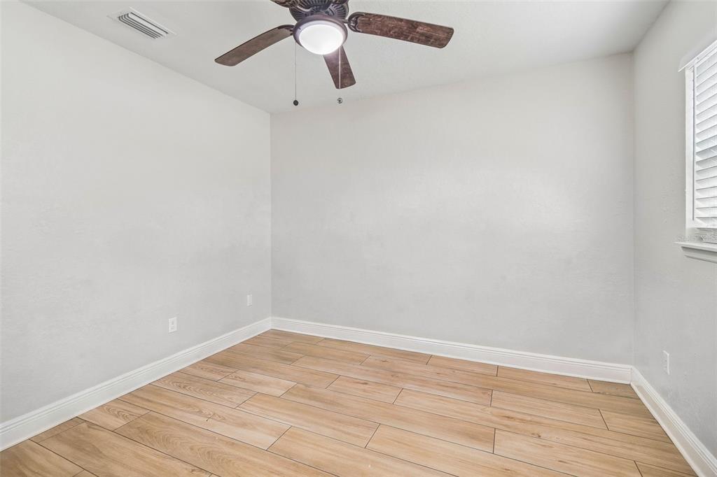 1618 Barry Road Clearwater, FL 33756 - Photo 35 of 71 an empty room with a window and a fan