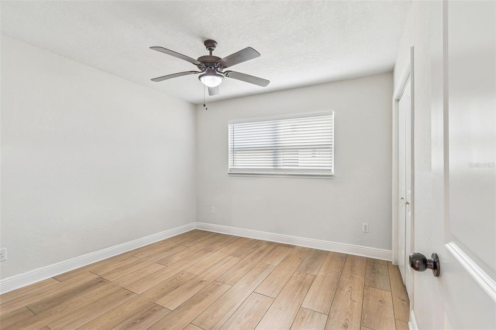 1618 Barry Road Clearwater, FL 33756 - Photo 36 of 71 wooden floor in an empty room with a window