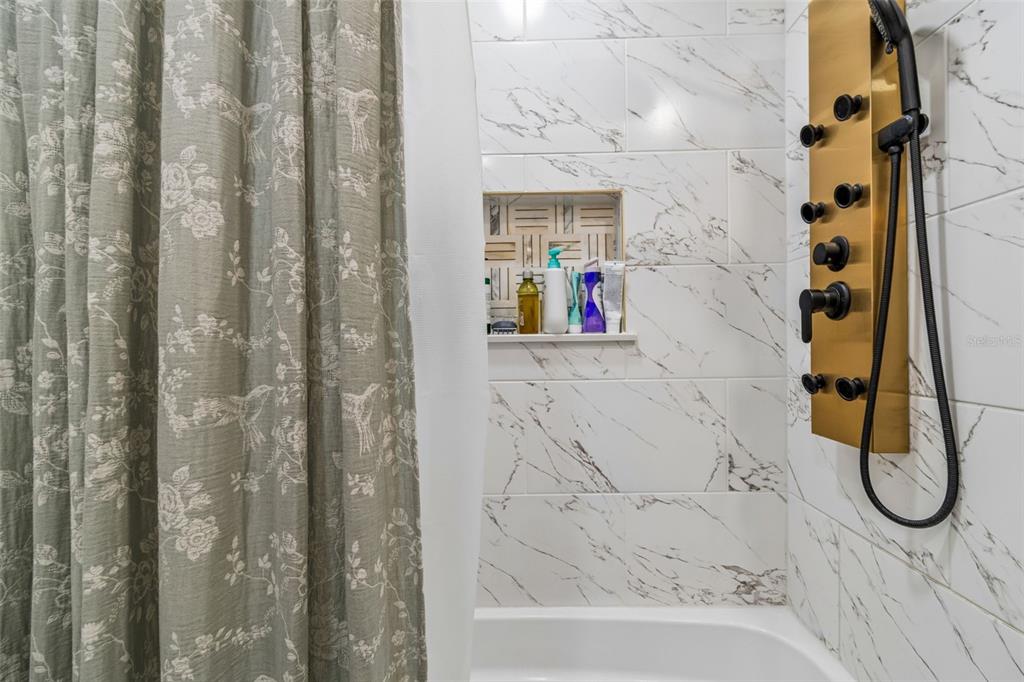 1618 Barry Road Clearwater, FL 33756 - Photo 37 of 71 a bathroom with a granite countertop shower and a sink