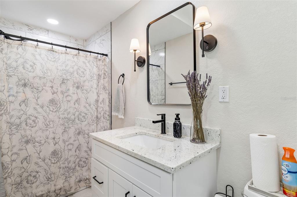 1618 Barry Road Clearwater, FL 33756 - Photo 41 of 71 a bathroom with a sink and a mirror