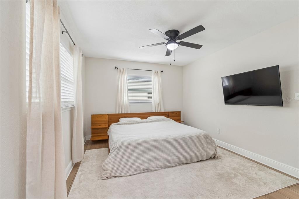 1618 Barry Road Clearwater, FL 33756 - Photo 43 of 71 a bedroom with a bed and a flat screen tv