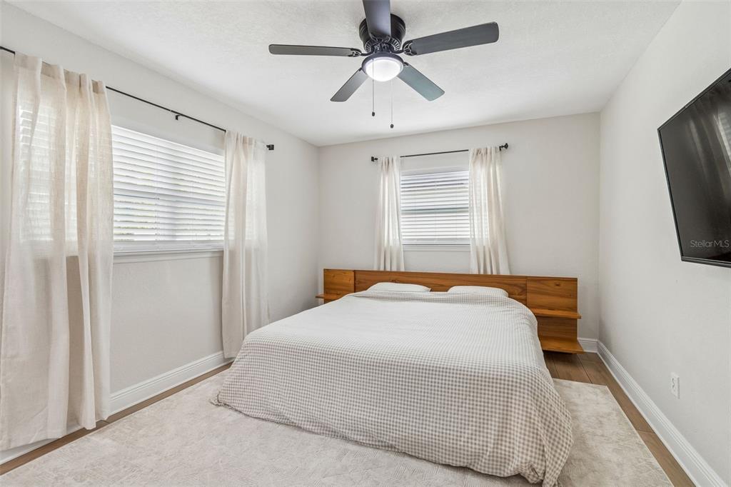 1618 Barry Road Clearwater, FL 33756 - Photo 44 of 71 a bedroom with a bed and a flat screen tv