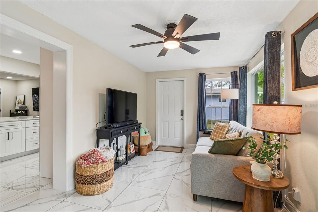 1618 Barry Road Clearwater, FL 33756 - Photo 47 of 71 a living room with furniture and a flat screen tv