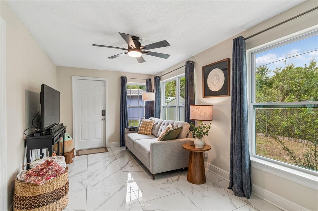 1618 Barry Road Clearwater, FL 33756 - Photo 49 of 71 a living room with furniture and a flat screen tv
