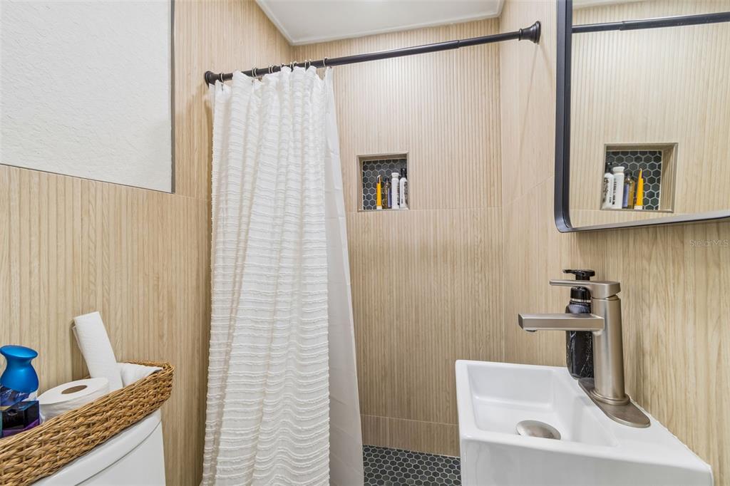 1618 Barry Road Clearwater, FL 33756 - Photo 54 of 71 a bathroom with a shower curtain and a sink